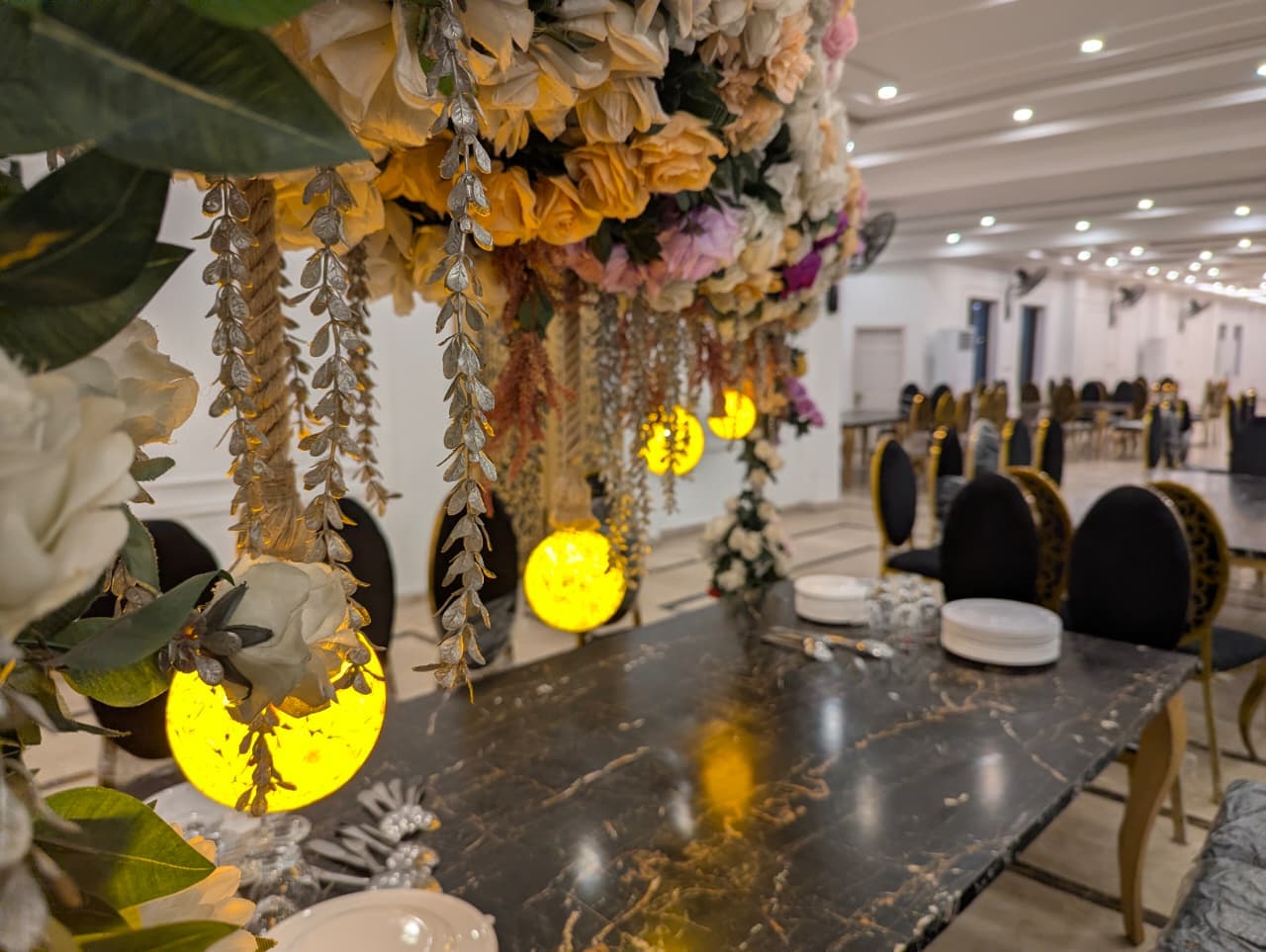 Lantern globes above a marble dining table