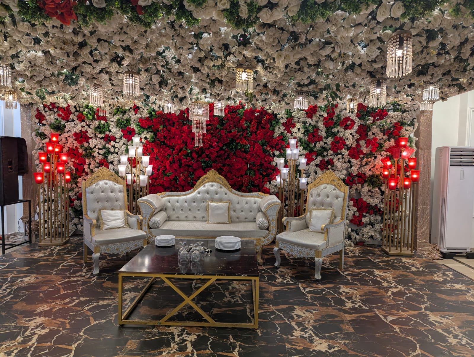 Red and white rose stage with chandeliers